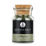 Dillspitzen von Ankerkraut im Korkenglas auf weißem Hintergrund.